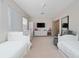Large bedroom with two single beds, a crib, and entertainment setup at 8108 Via Bella Notte, Orlando, FL 32836