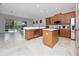 Bright kitchen featuring stainless steel appliances, a center island, and direct access to the outdoor living area at 8108 Via Bella Notte, Orlando, FL 32836