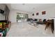 Spacious living room featuring a large sectional sofa and sliding glass doors leading to the patio and pool at 8108 Via Bella Notte, Orlando, FL 32836