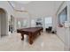 Open living room with high ceilings, travertine floors, and abundant natural light with views to the backyard at 8108 Via Bella Notte, Orlando, FL 32836