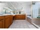 Spacious bathroom featuring dual sinks, a soaking tub, and a walk-in shower, offering a spa-like experience at 8108 Via Bella Notte, Orlando, FL 32836