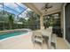 Relaxing screened-in patio with a pool and outdoor dining area, perfect for entertaining at 8108 Via Bella Notte, Orlando, FL 32836