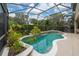 Inviting screened-in pool with unique shape, tile trim and a calming backyard view at 8108 Via Bella Notte, Orlando, FL 32836