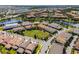 A high-angle view shows a community with multiple homes and a central pond at 10108 Sunnifa Aly, Orlando, FL 32832