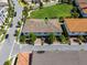 Birds eye view of roof with arrow indicator the location, a lush green lawn, tile roofs, and beautiful community at 10108 Sunnifa Aly, Orlando, FL 32832