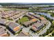 Aerial view showcasing multi-Gathering homes, a pond with a fountain, and green spaces in this community at 10108 Sunnifa Aly, Orlando, FL 32832