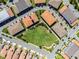 Birds-eye view showcasing the tile rooftops and street layouts, nestled within green spaces and neighborhood streets at 10108 Sunnifa Aly, Orlando, FL 32832