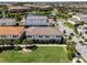 Stunning aerial view of a home with a tile roof in a community surrounded by lush landscaping and a serene lake at 10108 Sunnifa Aly, Orlando, FL 32832