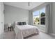 Bright bedroom with neutral colors, ceiling fan, and large windows that showcase outdoor views at 10108 Sunnifa Aly, Orlando, FL 32832