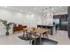 Open floor plan with dining area and kitchen featuring a large island, pendant lights, and sleek appliances at 10108 Sunnifa Aly, Orlando, FL 32832