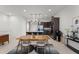 Dining area next to modern kitchen featuring pendant lighting, a dining table, and stainless steel appliances at 10108 Sunnifa Aly, Orlando, FL 32832