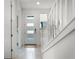 Bright entryway featuring tiled flooring, stairs, and a modern front door at 10108 Sunnifa Aly, Orlando, FL 32832