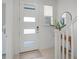 Bright entryway with modern door, tiled floor, and staircase at 10108 Sunnifa Aly, Orlando, FL 32832