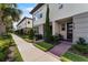 Stylish townhome with modern facade, lush landscaping, and brick pathway at 10108 Sunnifa Aly, Orlando, FL 32832