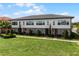 Modern townhome featuring a well-manicured lawn, symmetrical landscaping, and expansive windows for great natural light at 10108 Sunnifa Aly, Orlando, FL 32832