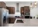 Modern kitchen with stainless steel appliances and a large island with granite countertops at 10108 Sunnifa Aly, Orlando, FL 32832