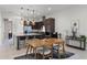 Modern kitchen with stainless steel appliances, granite counters, an island with bar seating, and pendant lighting at 10108 Sunnifa Aly, Orlando, FL 32832