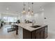 Bright and spacious kitchen island with stainless steel appliances, seamlessly connected to the living room at 10108 Sunnifa Aly, Orlando, FL 32832