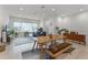 Open concept living space features a dining area and living room with modern furnishings at 10108 Sunnifa Aly, Orlando, FL 32832