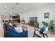 Spacious living room featuring a blue sofa, modern furniture, and seamless flow to the kitchen at 10108 Sunnifa Aly, Orlando, FL 32832