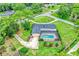 Aerial view of home with screened pool, mature landscaping and a long driveway at 1071 Deer Run Dr, Winter Springs, FL 32708