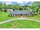 Aerial view of a beautiful home with a well-manicured lawn and lush landscaping at 1071 Deer Run Dr, Winter Springs, FL 32708