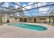 Sparkling screened-in pool area surrounded by lush landscaping and charming home exterior at 1071 Deer Run Dr, Winter Springs, FL 32708