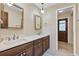 Bright bathroom featuring double sinks with wooden cabinets and a neutral color palette, creating a serene and functional space at 1071 Deer Run Dr, Winter Springs, FL 32708