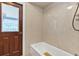 Bathroom features a tub, shower, and a door to the outside, offering convenience and functionality at 1071 Deer Run Dr, Winter Springs, FL 32708