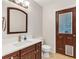 Bathroom boasts wood vanity, modern fixtures, and a door with a convenient pet door at 1071 Deer Run Dr, Winter Springs, FL 32708