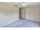 Spacious bedroom featuring a closet, a ceiling fan, and neutral walls, complemented by plush gray carpet at 1071 Deer Run Dr, Winter Springs, FL 32708