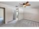 This bedroom includes a ceiling fan, carpet floors, and ensuite bath at 1071 Deer Run Dr, Winter Springs, FL 32708