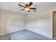 Cozy bedroom with plush gray carpet, a ceiling fan, and neutral walls creating a calming and inviting atmosphere at 1071 Deer Run Dr, Winter Springs, FL 32708