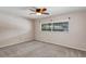 This bedroom includes a ceiling fan, carpet floors, and a window overlooking the backyard at 1071 Deer Run Dr, Winter Springs, FL 32708
