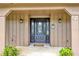 Beautiful front door with glass inlays, welcome decorations, and side sconces at 1071 Deer Run Dr, Winter Springs, FL 32708