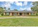Charming ranch style home with a brick and wood facade and a large, green front yard at 1071 Deer Run Dr, Winter Springs, FL 32708