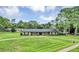 Beautiful ranch style home with a circular driveway and well-manicured lawn and landscaping at 1071 Deer Run Dr, Winter Springs, FL 32708