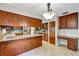 This kitchen features wood cabinets, granite counters, stainless steel appliances and a breakfast bar at 1071 Deer Run Dr, Winter Springs, FL 32708