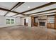 Spacious living room featuring a brick fireplace, built in shelves, and wood beam ceilings at 1071 Deer Run Dr, Winter Springs, FL 32708