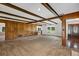 Cozy living room with wood paneling, carpet flooring, and exposed wood beam ceilings at 1071 Deer Run Dr, Winter Springs, FL 32708