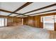 Large open living room with wood paneling, carpet, and view to a dining area at 1071 Deer Run Dr, Winter Springs, FL 32708