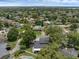Aerial view of a home with a dark roof, in a lush, green neighborhood with lakes and pools at 1105 Appleton Ave, Orlando, FL 32806
