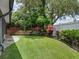 Well-manicured backyard featuring lush green grass, landscaping, and privacy fence at 1105 Appleton Ave, Orlando, FL 32806