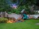Landscaped backyard featuring a patio seating area and play structure on a well-maintained lawn at 1105 Appleton Ave, Orlando, FL 32806