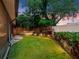Lush backyard featuring a manicured lawn, privacy fence, and thoughtfully placed landscape lighting at 1105 Appleton Ave, Orlando, FL 32806