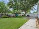 Spacious backyard featuring lush lawn, mature trees, a playset, and a white privacy fence at 1105 Appleton Ave, Orlando, FL 32806