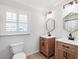 Modern bathroom featuring a double vanity with wood cabinets and black hardware at 1105 Appleton Ave, Orlando, FL 32806