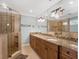 Spacious bathroom features a double vanity, large mirror and tiled shower at 1105 Appleton Ave, Orlando, FL 32806
