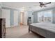 Bright bedroom features light blue walls, white trim, fan, and wood-look flooring at 1105 Appleton Ave, Orlando, FL 32806