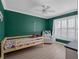 Bright bedroom with bold green accent wall and wood frame bed at 1105 Appleton Ave, Orlando, FL 32806